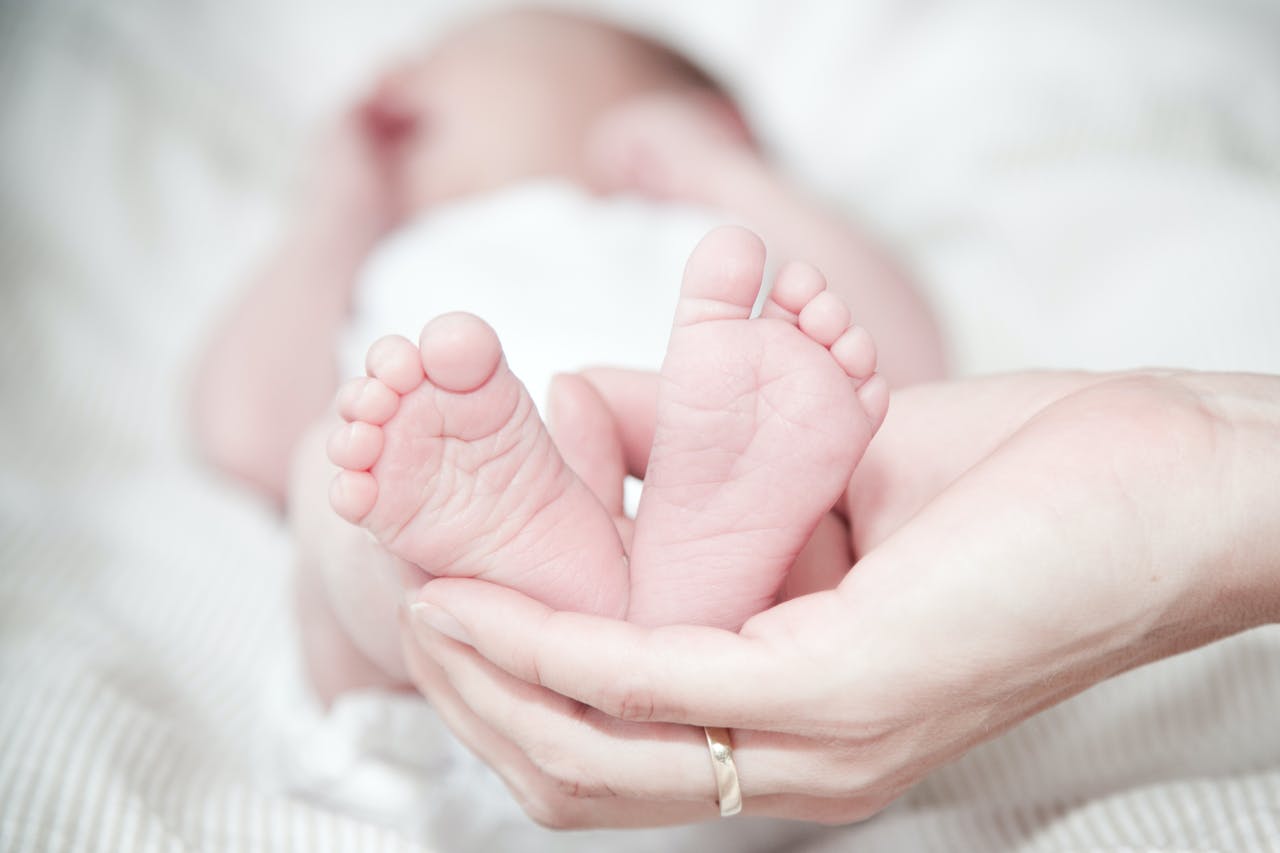 Hands Holding Baby's Feet