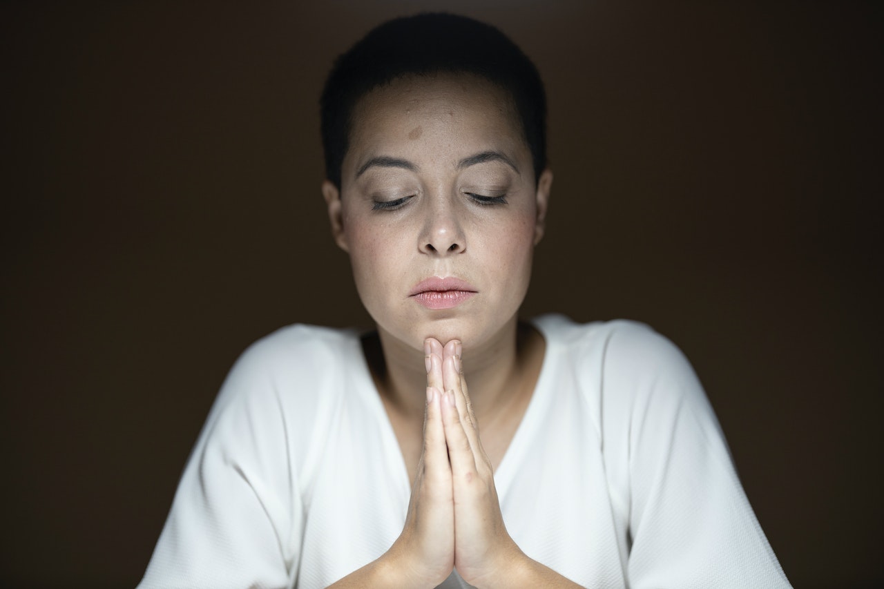 Woman Wearing White Long-sleeved Shirt Prayng