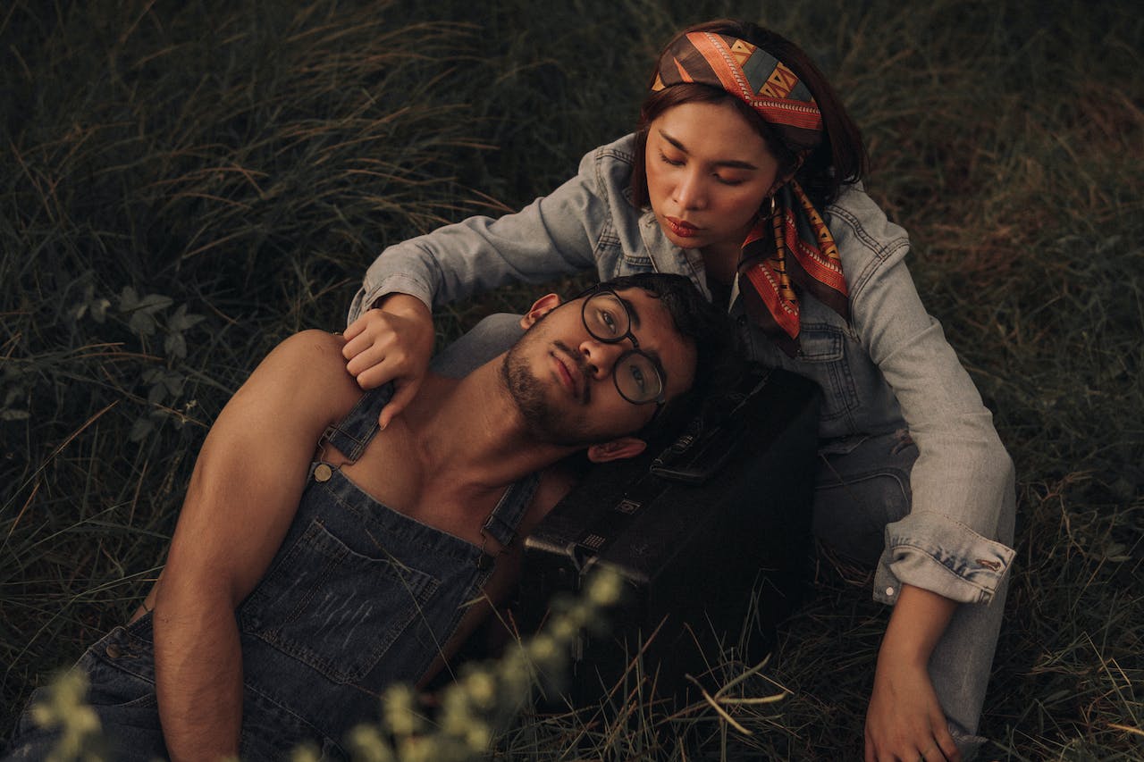 Couple Relaxing On Grassland