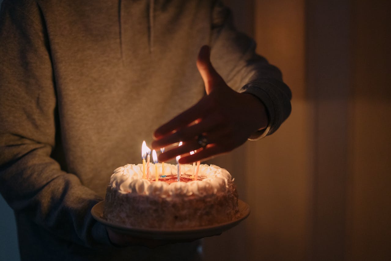 Person Holding a Birthday Cake