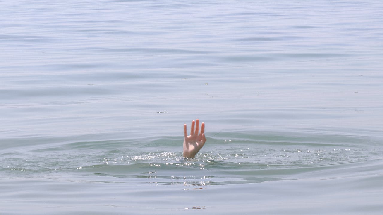 Person's Hand Above Water