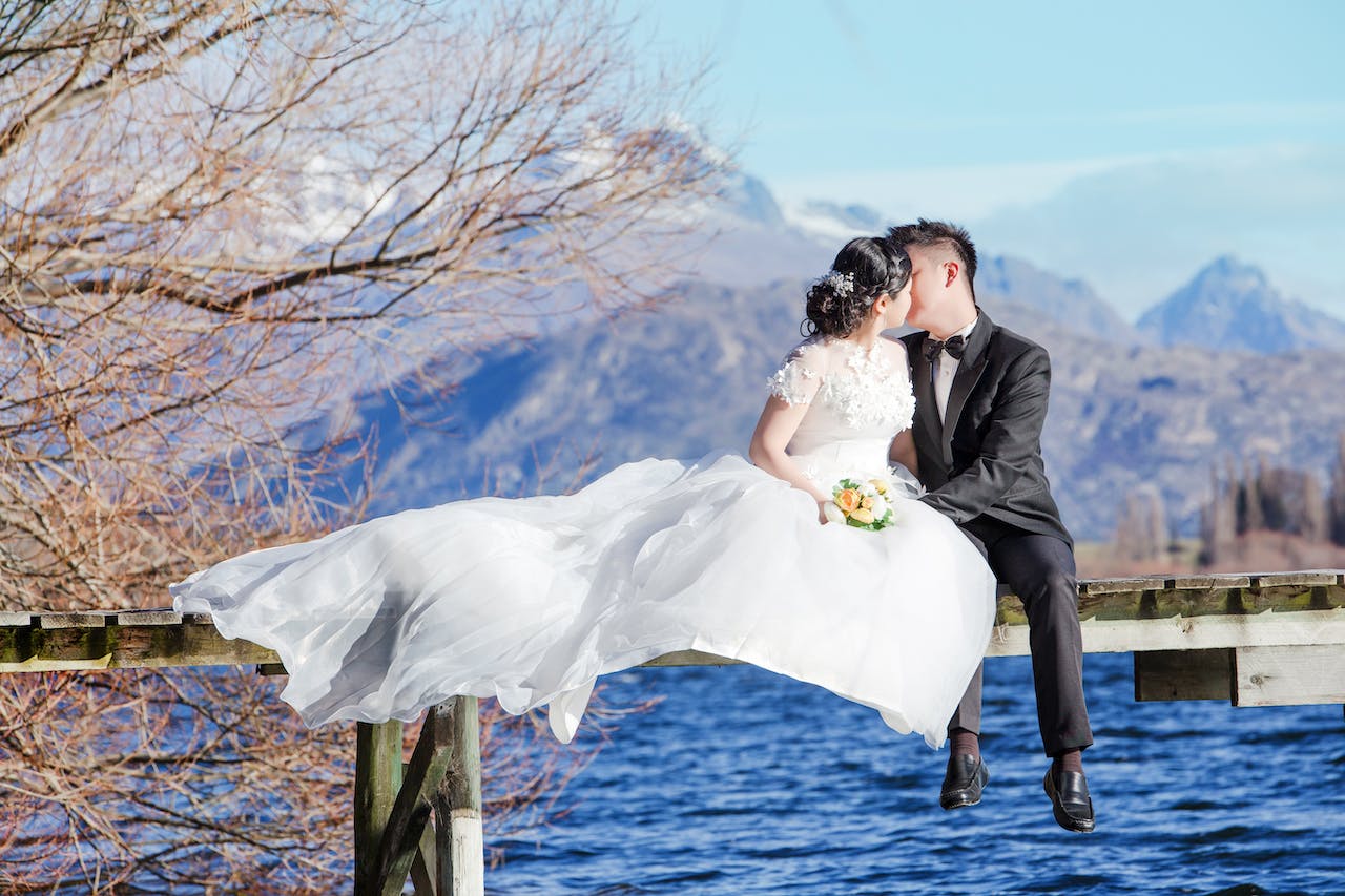 Man and Woman Kissing on Top of Water Dock