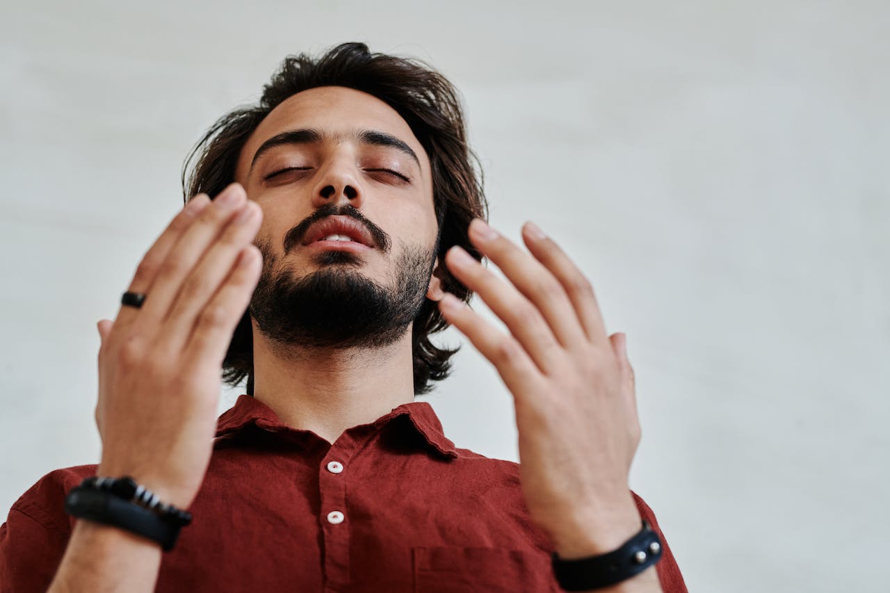 Low-Angle Shot of a Bearded Man Praying