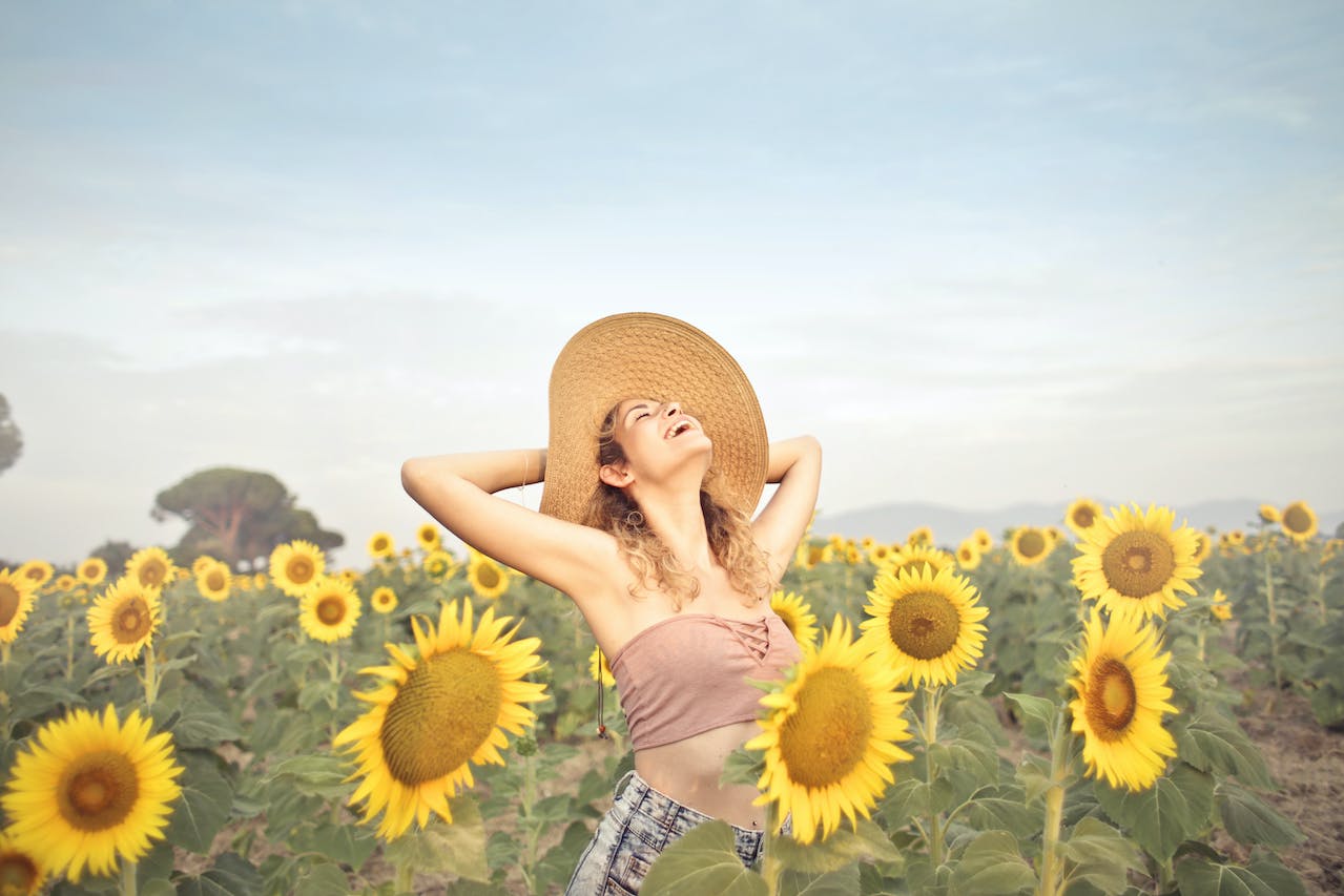 Woman Standing on a Sunflower Field