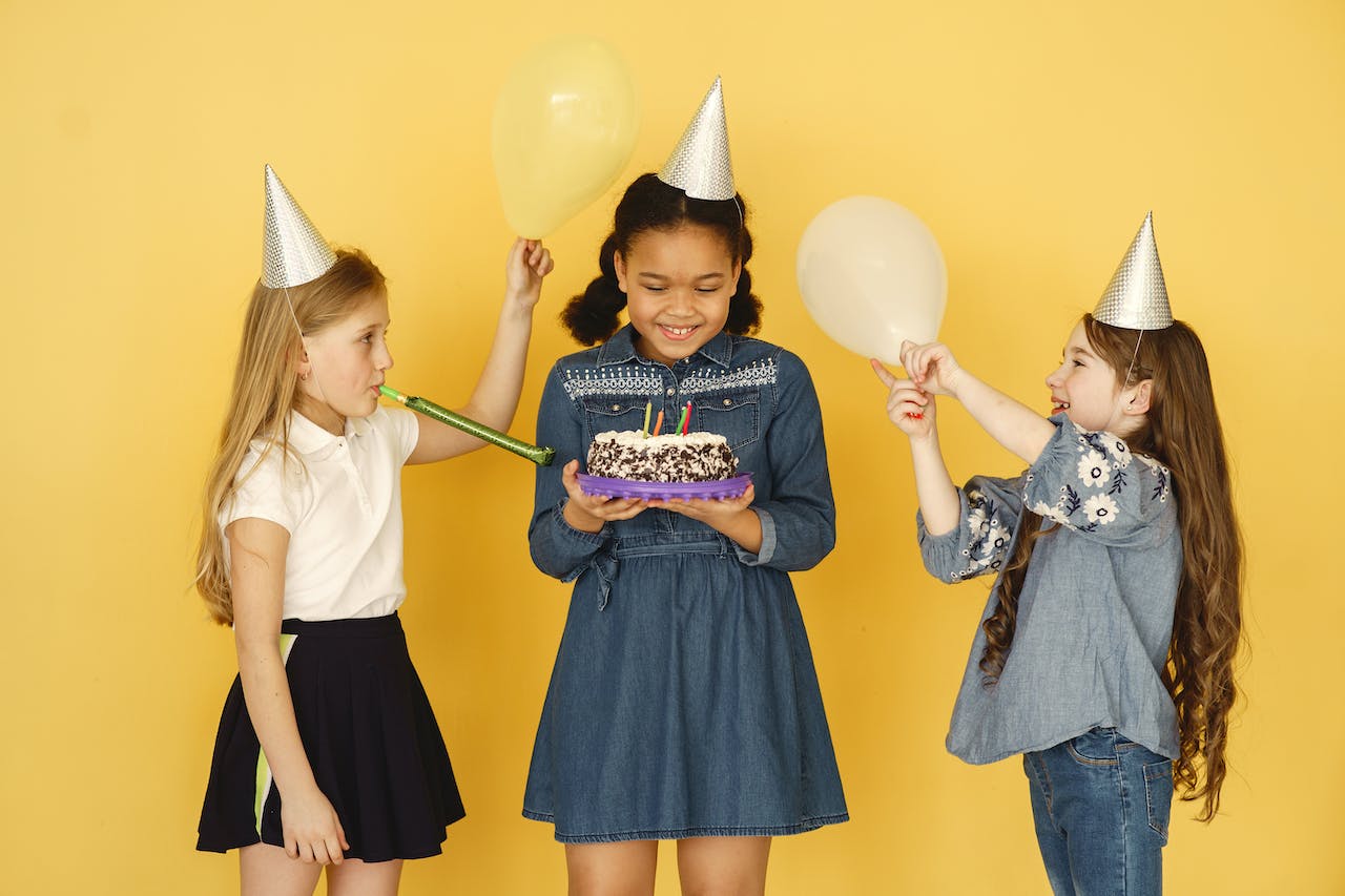 Kids Holding Balloons and Cake